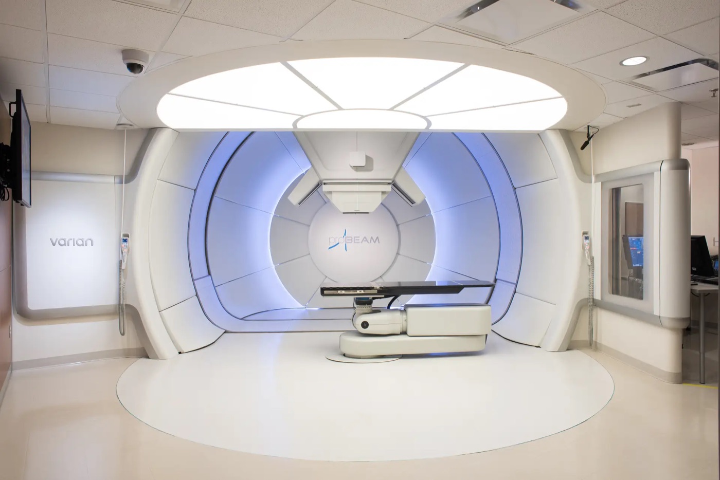 Varian ProBeam Compact proton therapy treatment room in Singapore, with patient positioning table and 360-degree rotating gantry